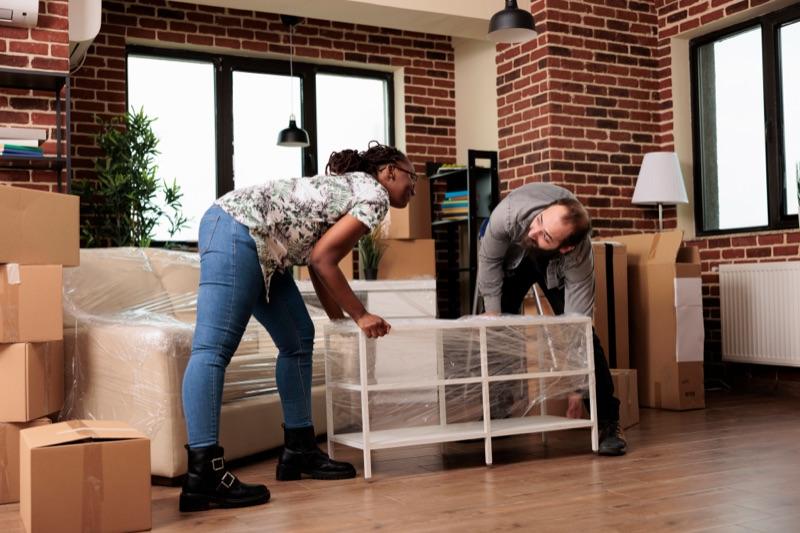 People packing and wrapping furniture for donation