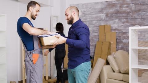 Workers handing donation box to recipient