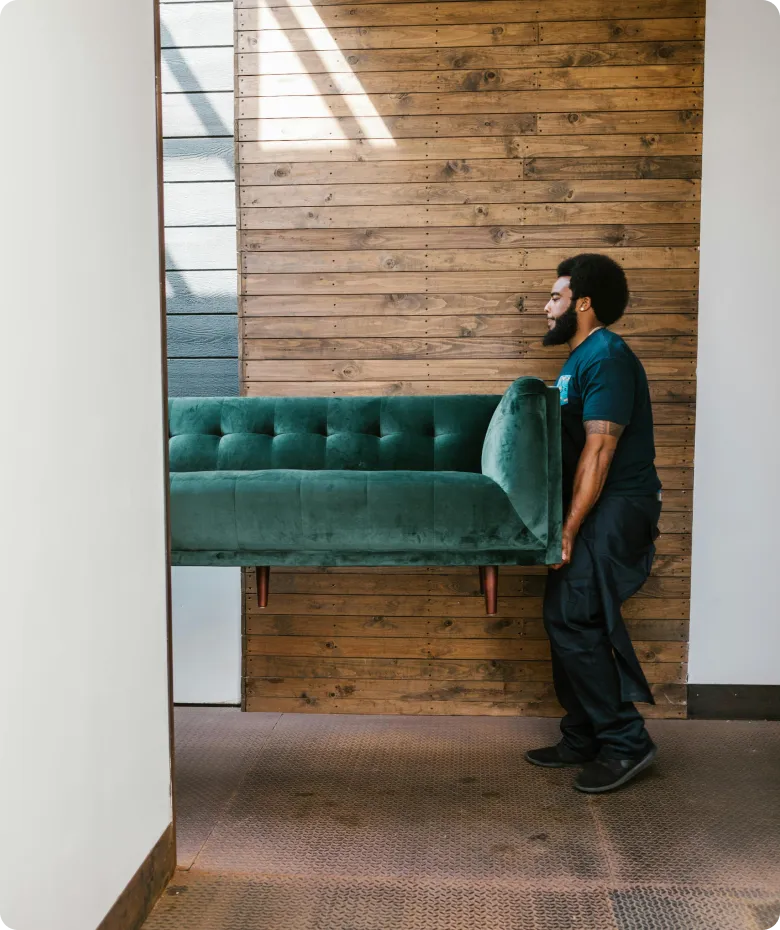Person carrying furniture in a modern interior